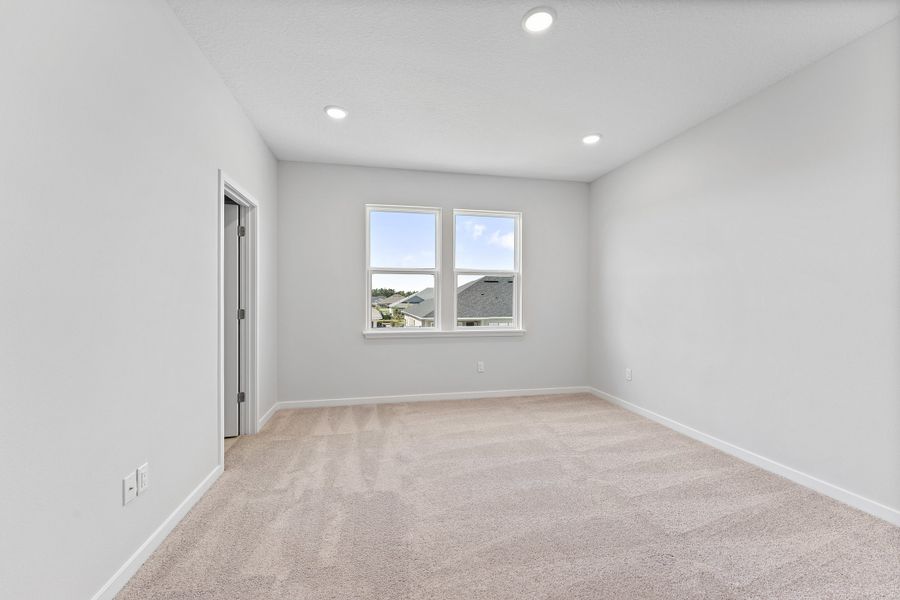 Lot 20 Ponderosa II Primary Bedroom with Large Windows at Camden Woods in Kingsland, GA