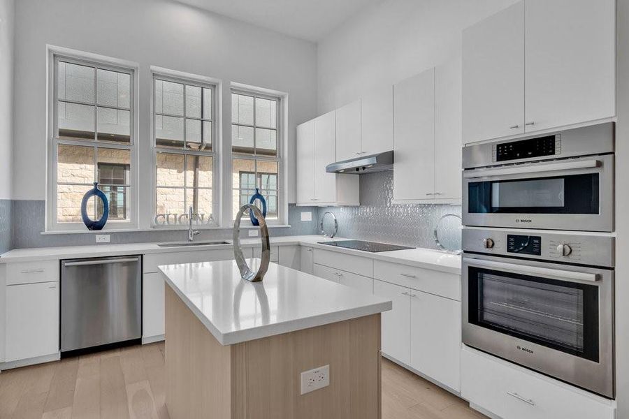 Similar home and finishes with subtle tones.  Actual appliances are upgraded Fisher and Paykel appliances with double drawer dishwasher, a gas range that says.....where is the chef?