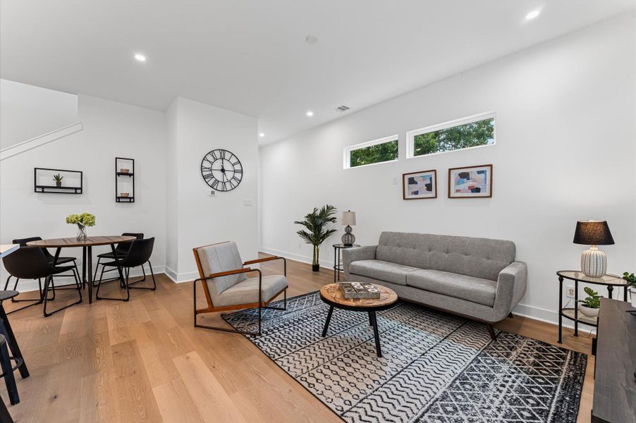 This inviting home features a spacious open-concept layout on the first floor, seamlessly connecting the living, dining, and kitchen areas to create a warm and functional gathering space. Large windows and glass door direct access to the backyard flooding the interior with natural light and extending the living space outdoors, perfect for entertaining or relaxing in the fresh air. The thoughtful design balances comfort and flow, making everyday living feel effortlessly connected to nature.