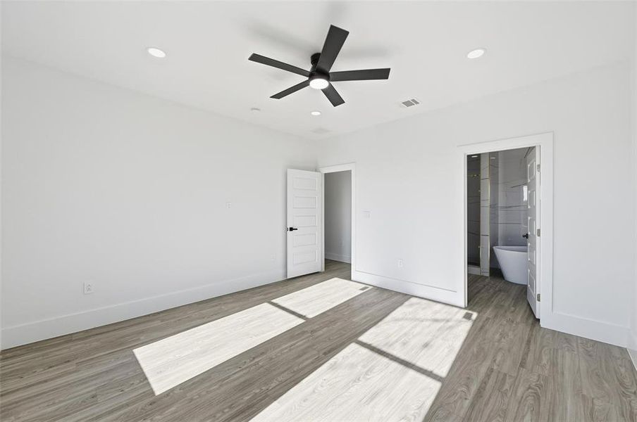 Unfurnished bedroom featuring light wood-style floors, ceiling fan, and recessed lighting Unfurnished bedroom featuring light wood-style floors, ceiling fan, and recessed lighting