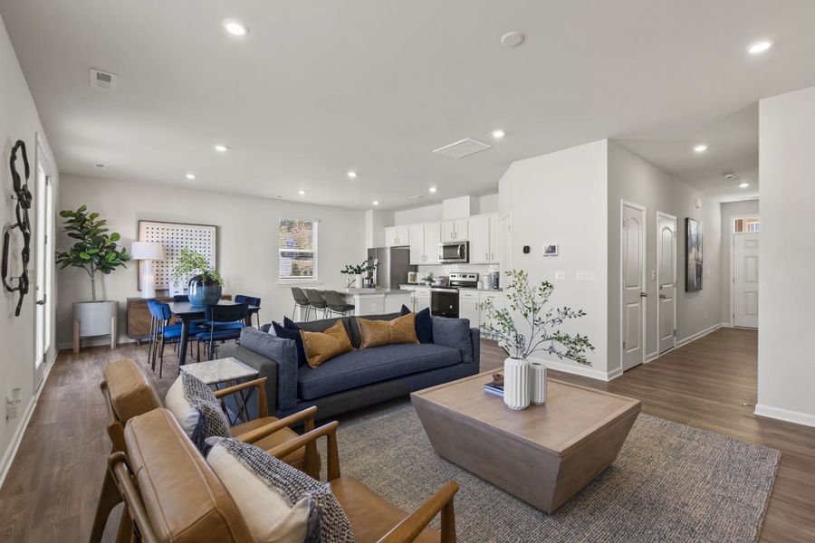 A living room with a couch and chairs.