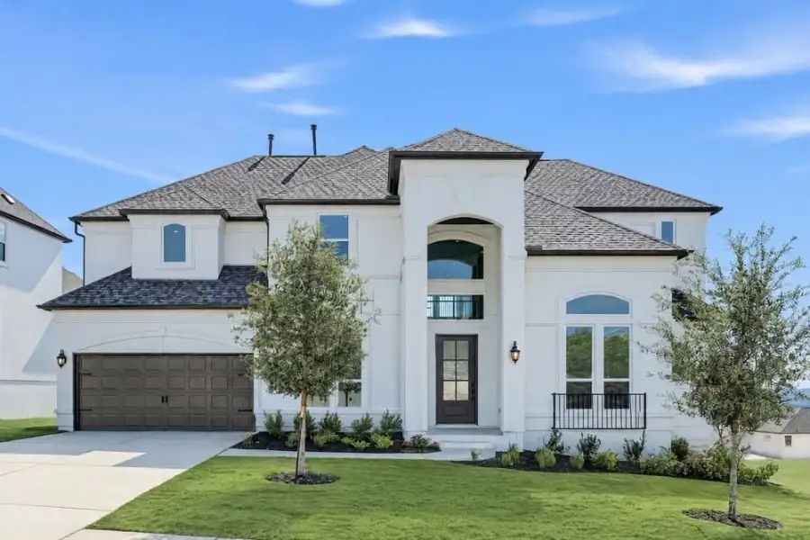 Front exterior of a new home in Travisso, Leander, TX, highlighting curb appeal (Image 1). Front exterior of a new home in Travisso, Leander, TX, highlighting curb appeal (Image 1).