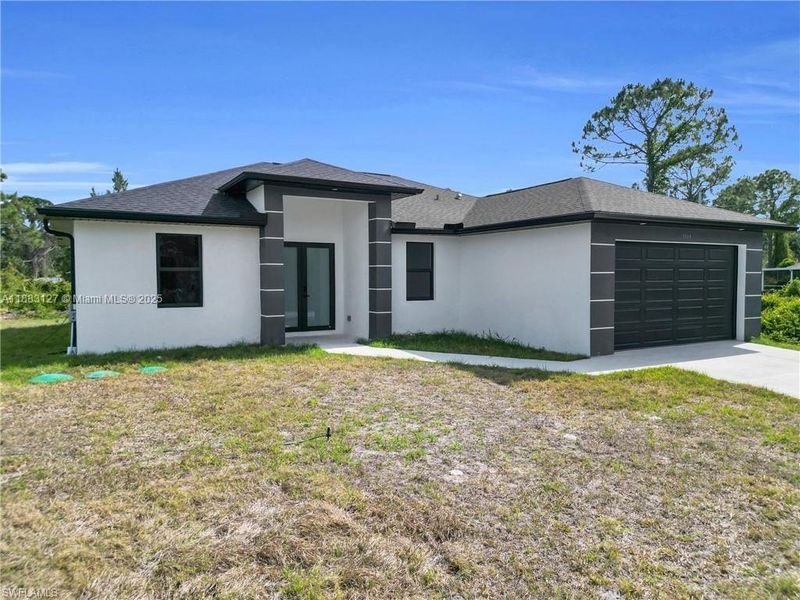 Front exterior of a new home in , Lehigh Acres, FL, highlighting curb appeal (Image 12).