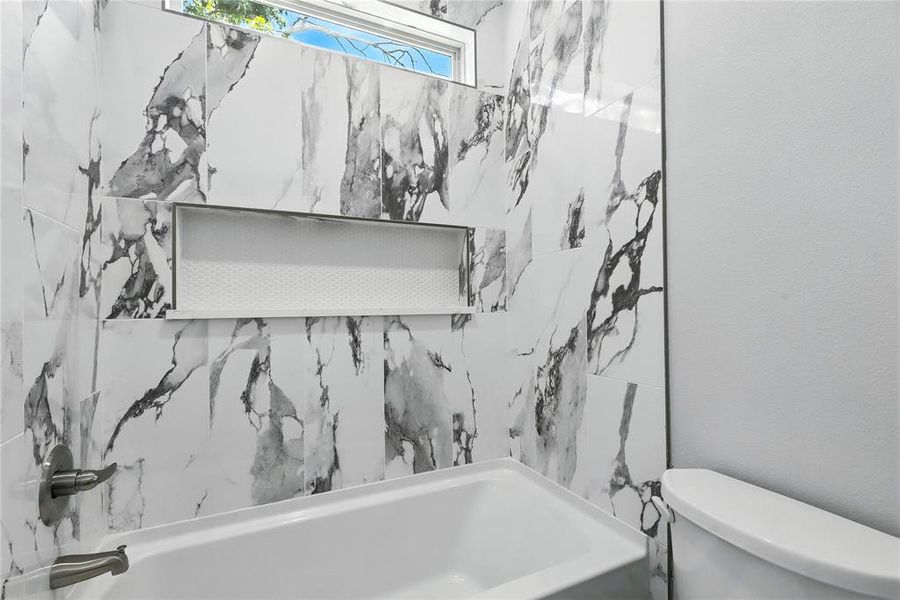 Full bathroom featuring toilet and shower / tub combination