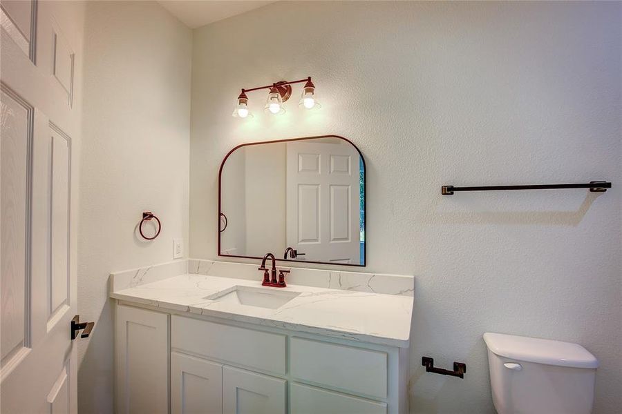 Half bath with vanity and toilet Half bath with vanity and toilet