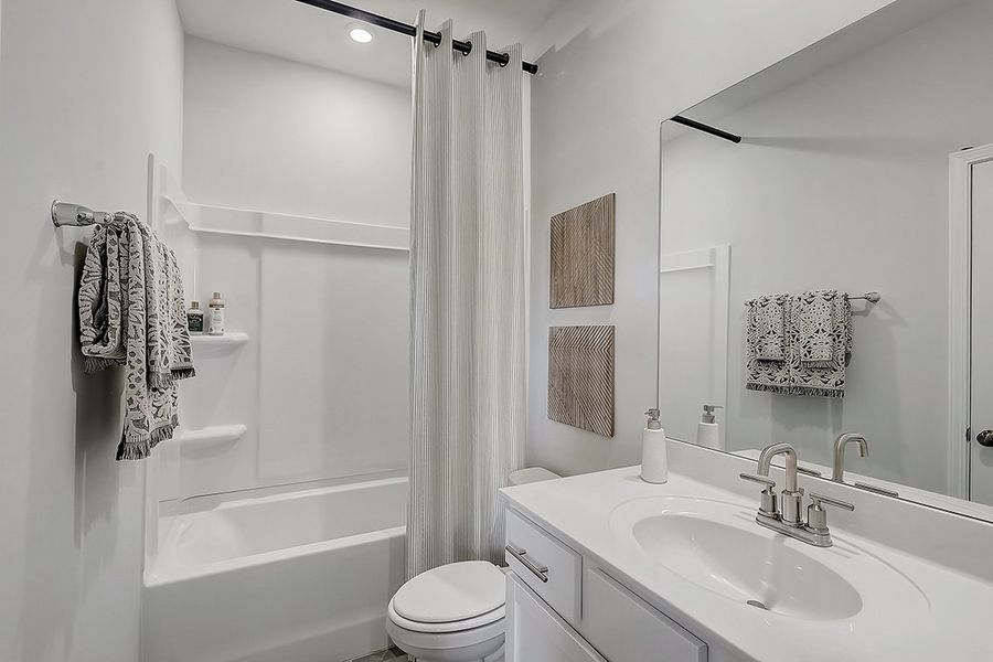 A bathroom with a sink and a shower.
