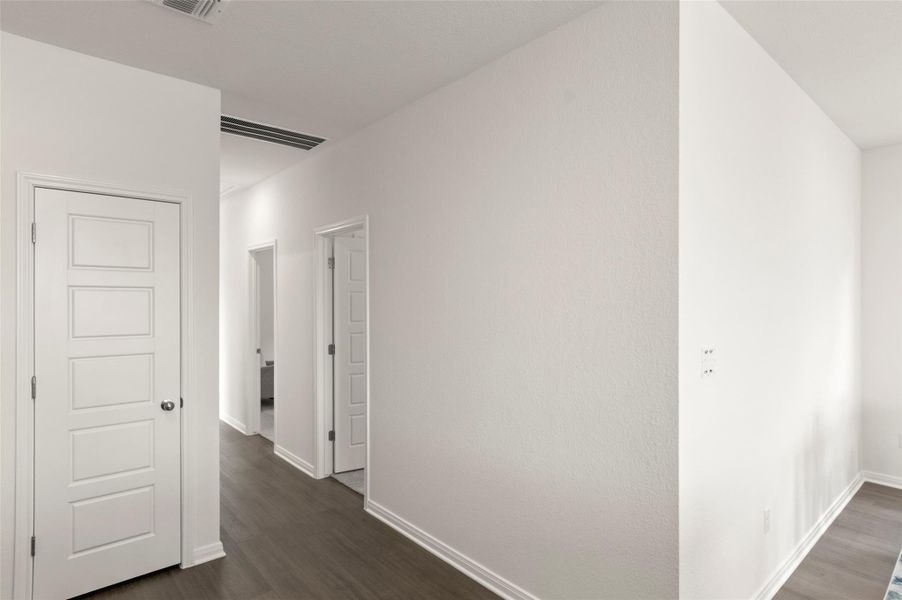 Hall featuring dark wood-style floors and baseboards