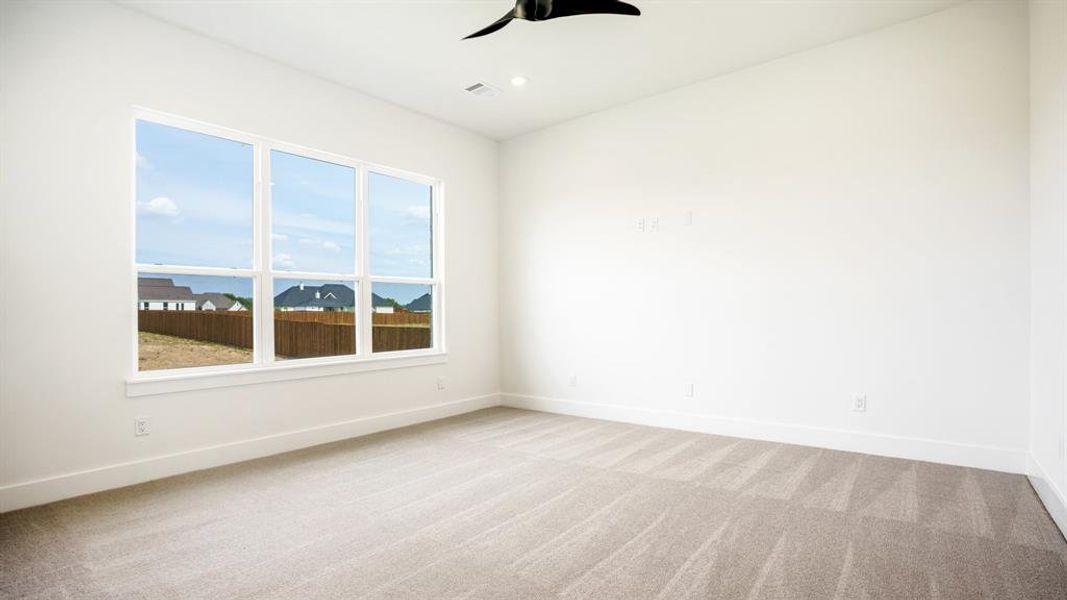 Spare room featuring ceiling fan and light colored carpet