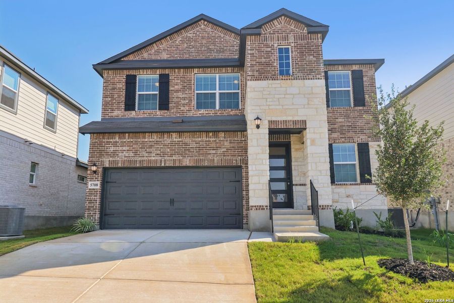 Front exterior of a new home in Thomas Pond, San Antonio, TX, highlighting curb appeal (Image 29).