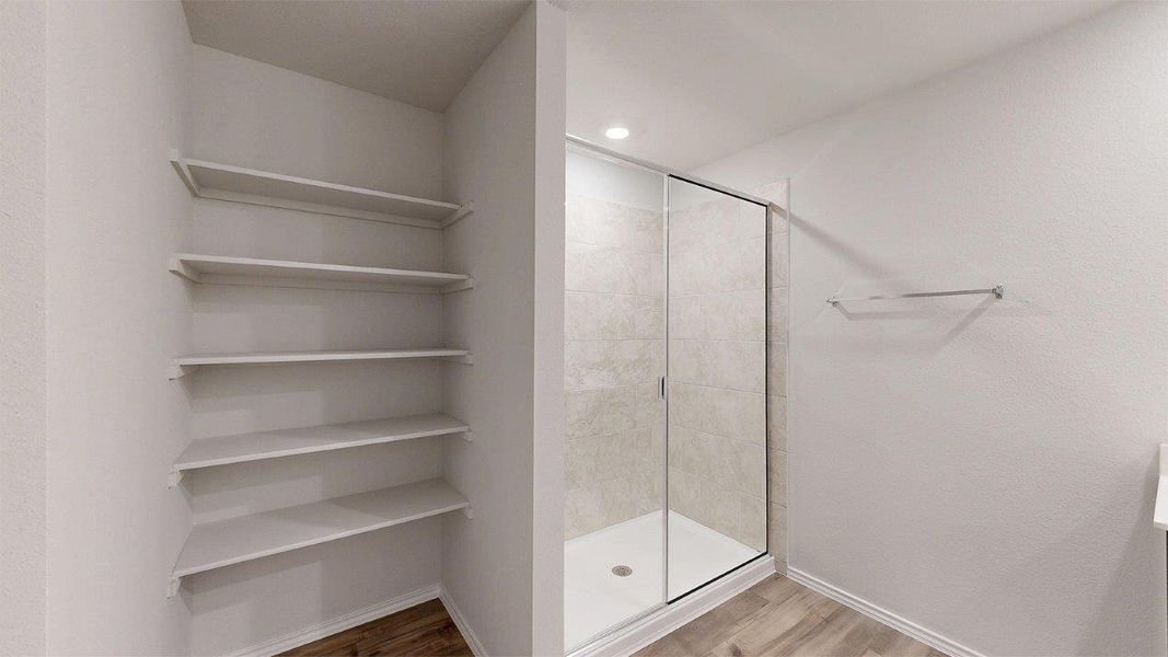 Walk-in shower with clear glass enclosure and light-toned tile surround Walk-in shower with clear glass enclosure and light-toned tile surround