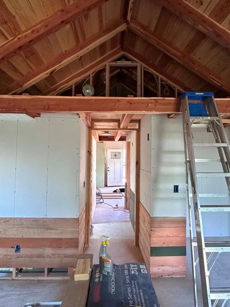 Exposed wood beams create architectural interest in this developing interior space.