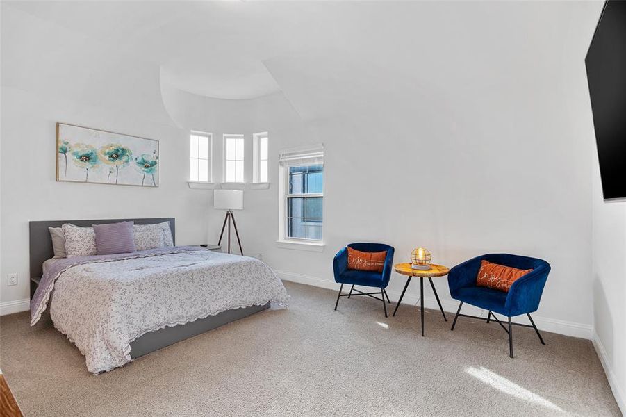 Bedroom featuring carpet floors and baseboards