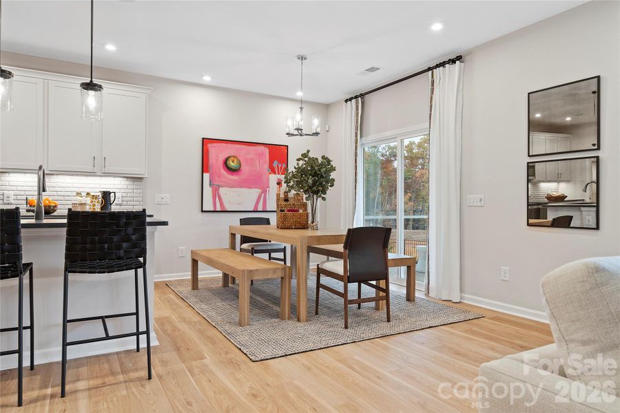 Large sliding glass doors leading to covered outdoor living.