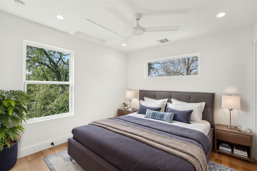 Bedroom featuring multiple windows, attic access, wood finished floors, a ceiling fan, and recessed lighting