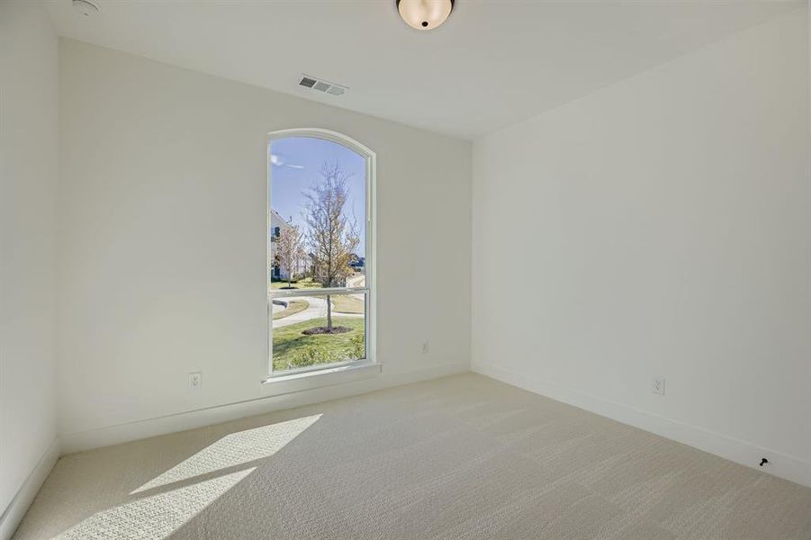 Empty room featuring carpet flooring and baseboards Empty room featuring carpet flooring and baseboards