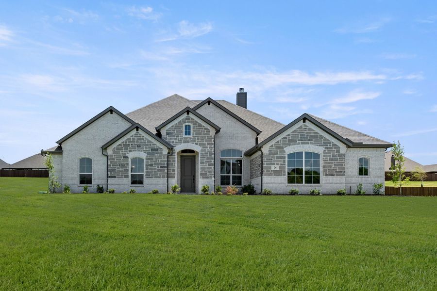 Front exterior of a new home in Mockingbird Hills - Premiere Series, Joshua, TX, highlighting curb appeal (Image 1). Front exterior of a new home in Mockingbird Hills - Premiere Series, Joshua, TX, highlighting curb appeal (Image 1).