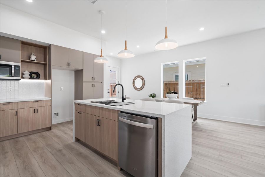 Anchoring the kitchen island is a charming undermount farmhouse sink, combining classic farmhouse style with modern functionality. Perfect for family meals or entertaining, it makes everyday tasks effortless while adding a warm, inviting touch to the heart of the home. This thoughtfully designed island becomes both a centerpiece and a hub for gathering.