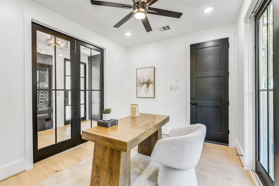 Elegant double glass doors, sleek ceiling fan, and designer lighting create a sophisticated atmosphere for productivity or client meetings, complemented by seamless access to the ensuite bath. Elegant double glass doors, sleek ceiling fan, and designer lighting create a sophisticated atmosphere for productivity or client meetings, complemented by seamless access to the ensuite bath.