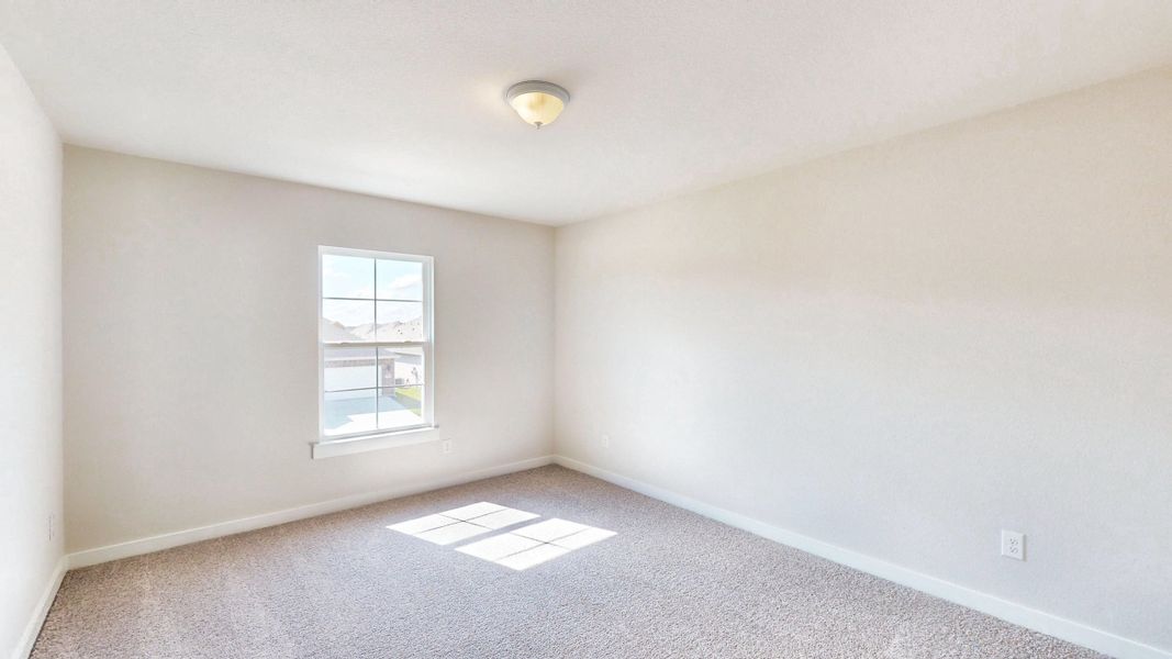 A room with a window and a carpet.