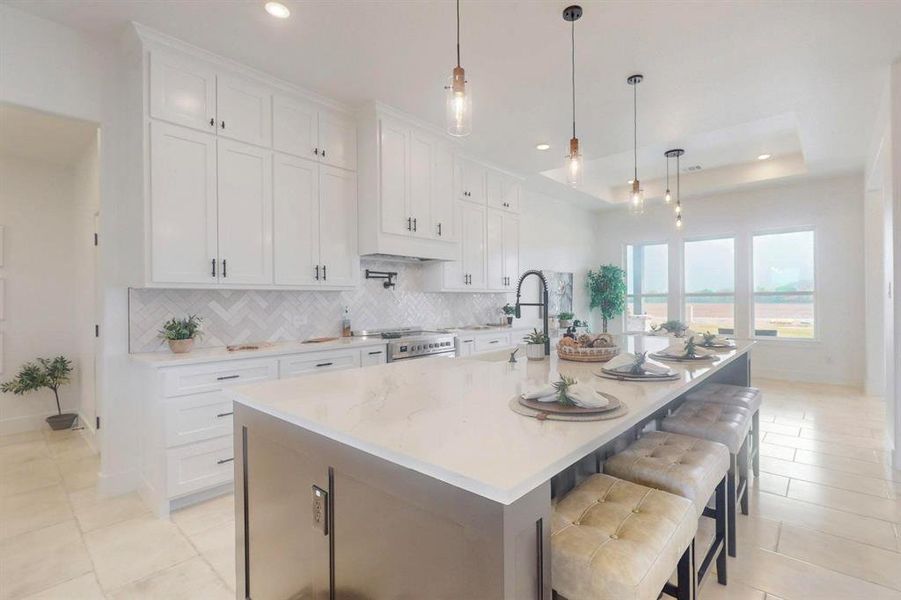Kitchen featuring white cabinetry, a raised ceiling, and decorative backsplash Kitchen featuring white cabinetry, a raised ceiling, and decorative backsplash