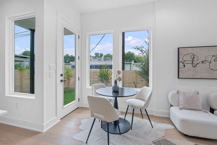 Dining space with light wood-type flooring and baseboards