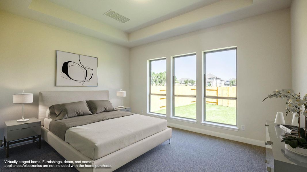 Carpeted bedroom featuring a tray ceiling Carpeted bedroom featuring a tray ceiling
