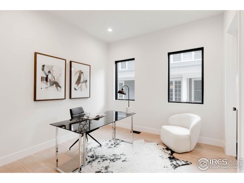 You'll find a convenient guest suite or office with a handsome herringbone tile shower on the main level.