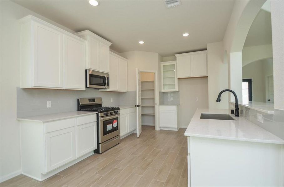 This gourmet kitchen offers ample cabinet space, sleek countertops, and top-of-the-line appliances. With plenty of storage and a built-in pantry, it’s designed to meet all your culinary needs. The open layout keeps the kitchen connected to the main living areas, perfect for entertaining or family time.