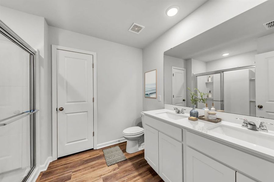Private Owner's Bath with a walk-in shower and timeless wood flooring. Private Owner's Bath with a walk-in shower and timeless wood flooring.