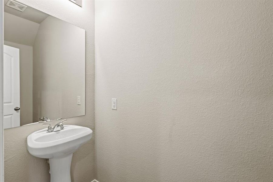 Bathroom featuring a textured wall Bathroom featuring a textured wall