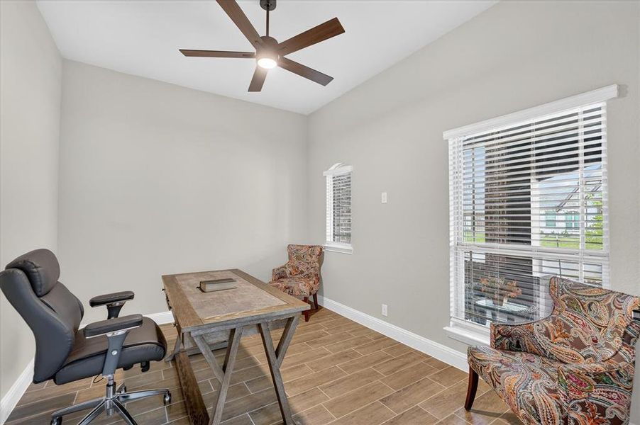 Interior room featuring sloped ceilings, wood-finish tile flooring, and neutral wall paint Interior room featuring sloped ceilings, wood-finish tile flooring, and neutral wall paint