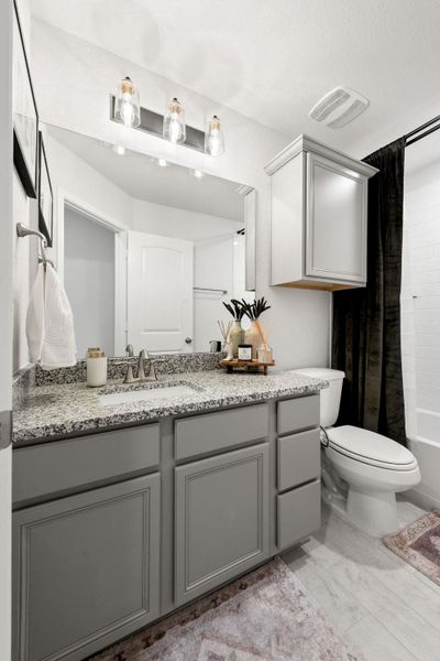 Full bath with vanity and shower / bath combo with shower curtain