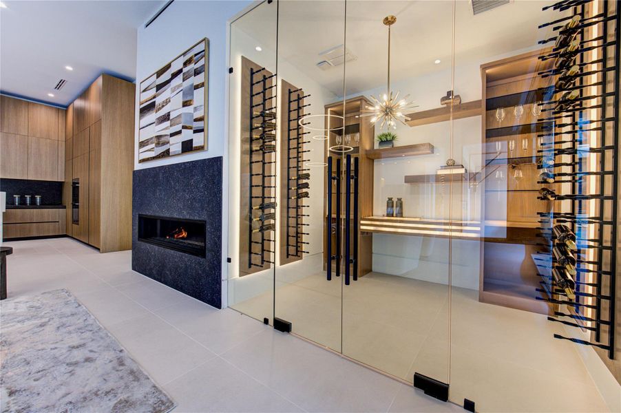 Glass-enclosed, temperature-controlled wine room.