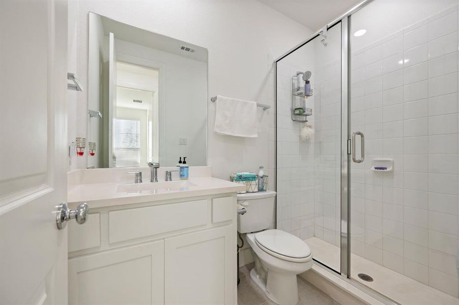 Bathroom featuring vanity and a stall shower