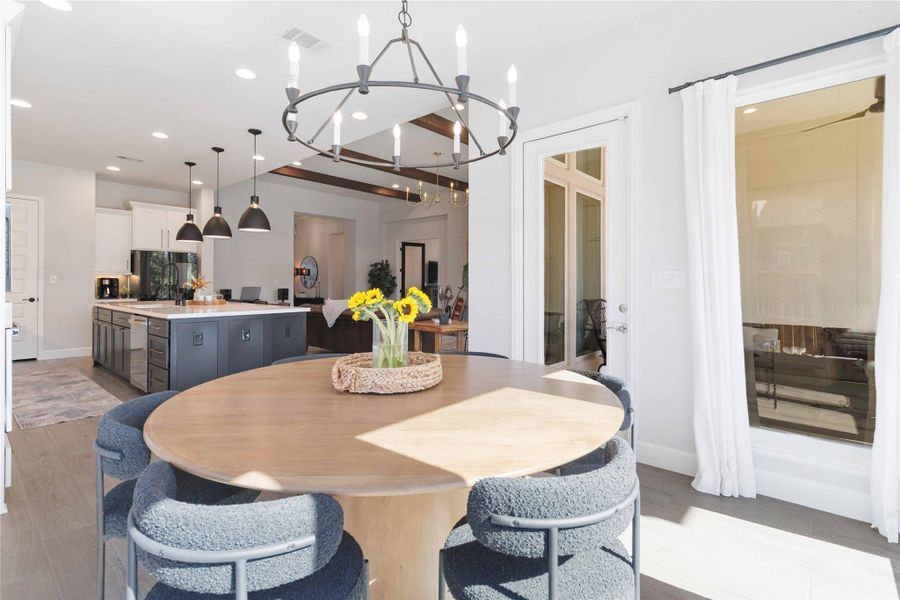 Dining space with light wood-style flooring, a chandelier, and recessed lighting Dining space with light wood-style flooring, a chandelier, and recessed lighting