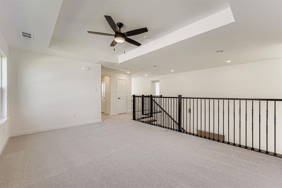 Spare room with light colored carpet, recessed lighting, and a ceiling fan