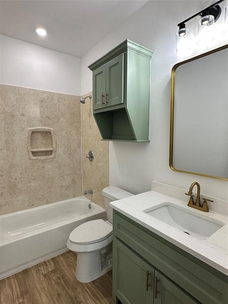 Full bath featuring shower / bathtub combination, wood finished floors, and vanity
