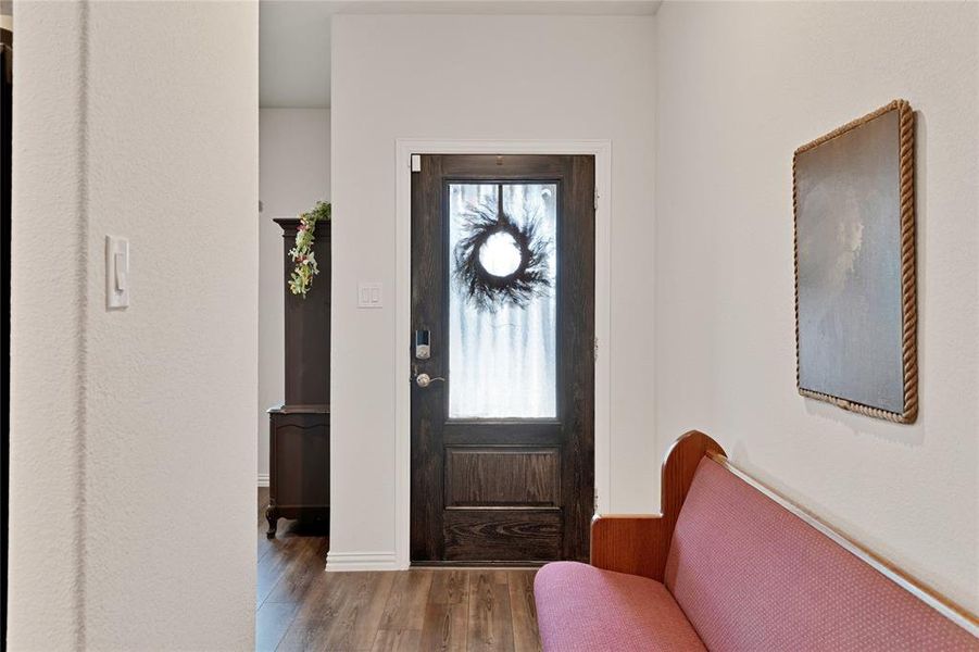 Foyer with plenty of natural light and wood finished floors