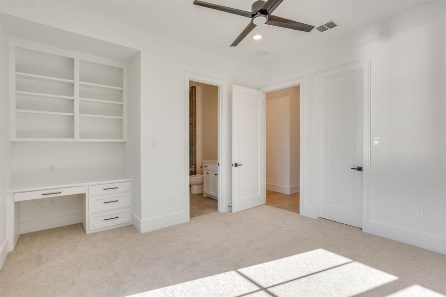 Unfurnished bedroom with light carpet, recessed lighting, a ceiling fan, a desk, and ensuite bath
