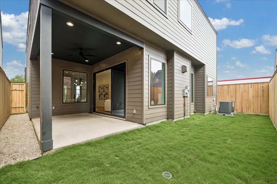 Backyard has a covered patio with a ceiling fan. Backyard has a covered patio with a ceiling fan.