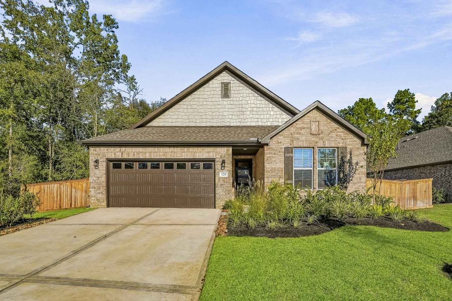 Front exterior of a new home in The Woodlands Hills, Willis, TX, highlighting curb appeal (Image 1). Front exterior of a new home in The Woodlands Hills, Willis, TX, highlighting curb appeal (Image 1).