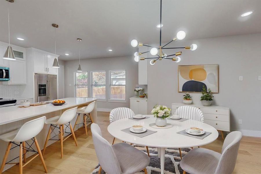 Virtual Staged Dining room featuring a chandelier and light wood-type flooring