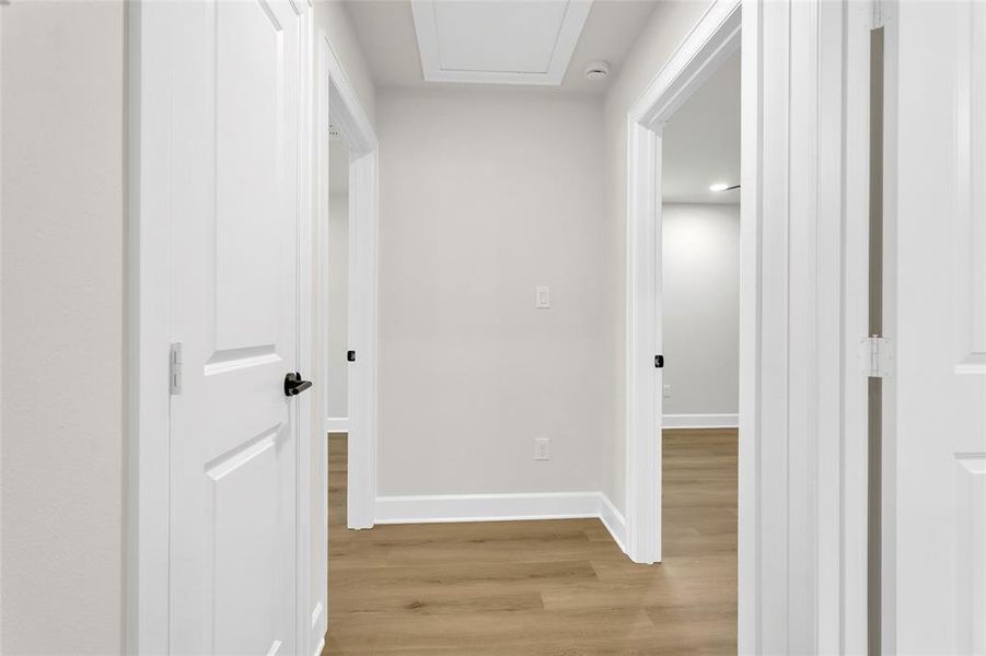 Corridor with light wood-style flooring and baseboards Corridor with light wood-style flooring and baseboards