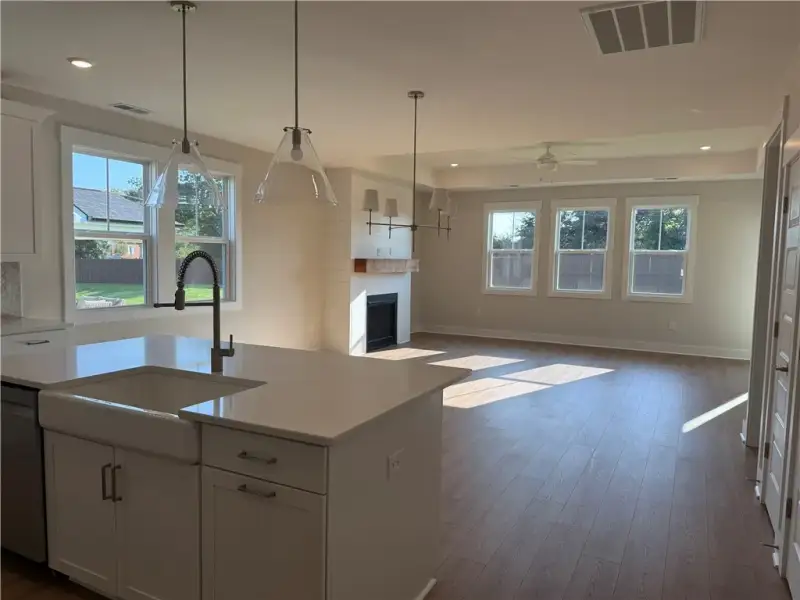 Gleaming hardwood floors and a cozy fireplace anch