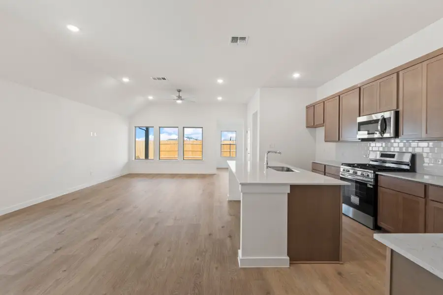 Kitchen in the Quartz home plan by Trophy Signature Homes – REPRESENTATIVE PHOTO