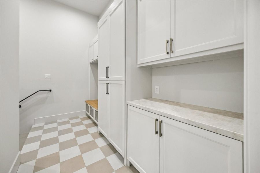 The mud room provides a polished everyday drop zone with built-in storage, keeping bags, shoes, and daily essentials organized and out of sight. The mud room provides a polished everyday drop zone with built-in storage, keeping bags, shoes, and daily essentials organized and out of sight.