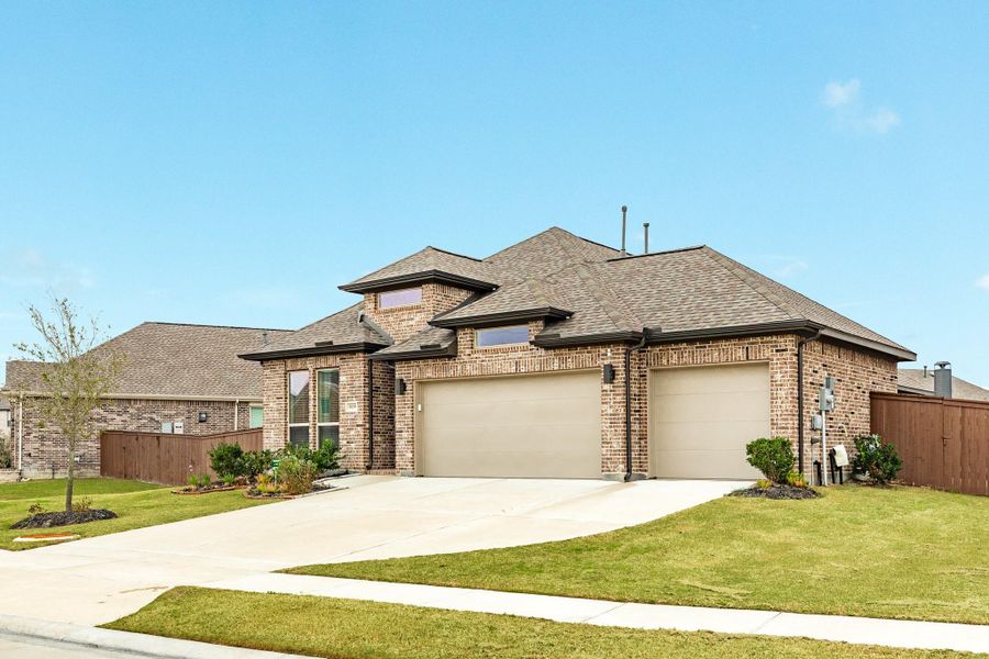 Side view of new home with triple driveway. Side view of new home with triple driveway.