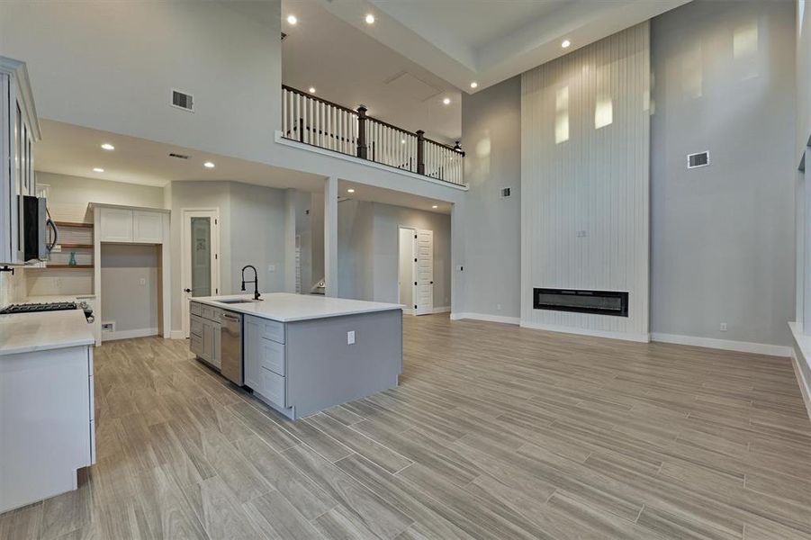 Another view of the fireplace with catwalk overlooking the living room. A powder room is just beyond.