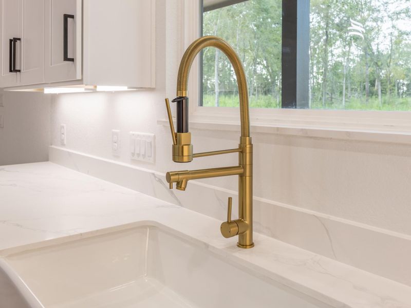 A closer look at the elegant brushed gold pull-down faucet and marble-inspired countertops—adding just the right amount of glam to your daily routine. A closer look at the elegant brushed gold pull-down faucet and marble-inspired countertops—adding just the right amount of glam to your daily routine.