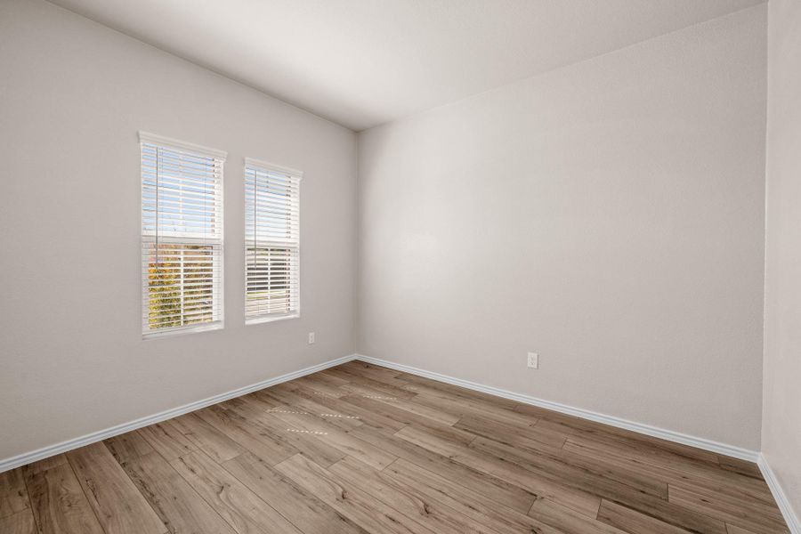 Unfurnished room featuring light wood-style floors and baseboards
